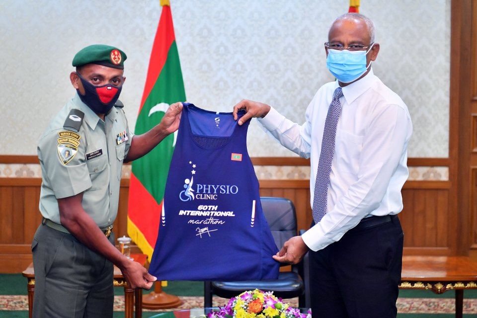 Marathoner Nasrullah presents his 60th medal and jersey to the President