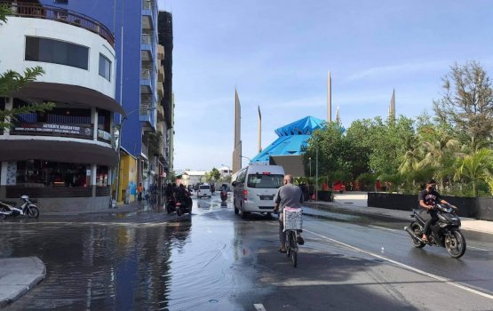 Waves crash inland filling Artificial Beach area