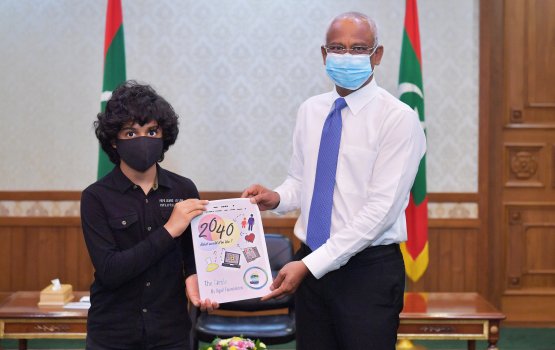 President presented with two books authored by Children